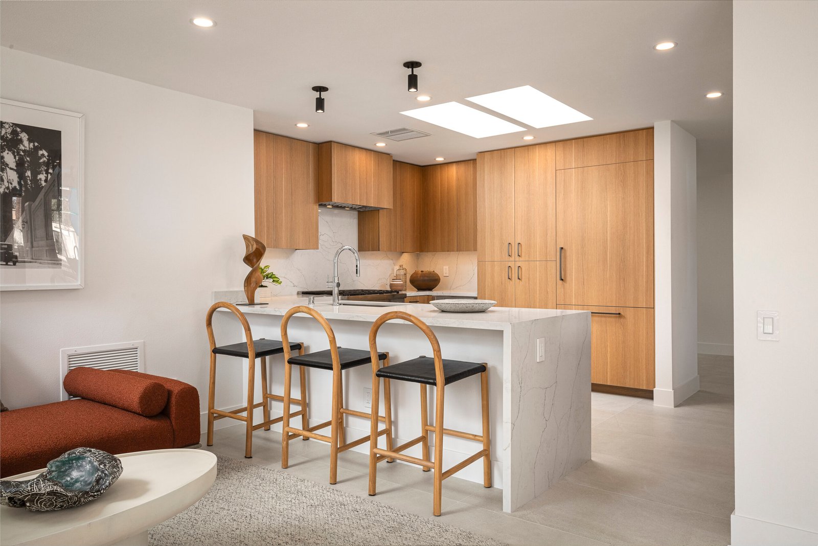 Open-plan custom kitchen with panel-ready cabinets and island bar seating open to living room, Rancho Mirage
