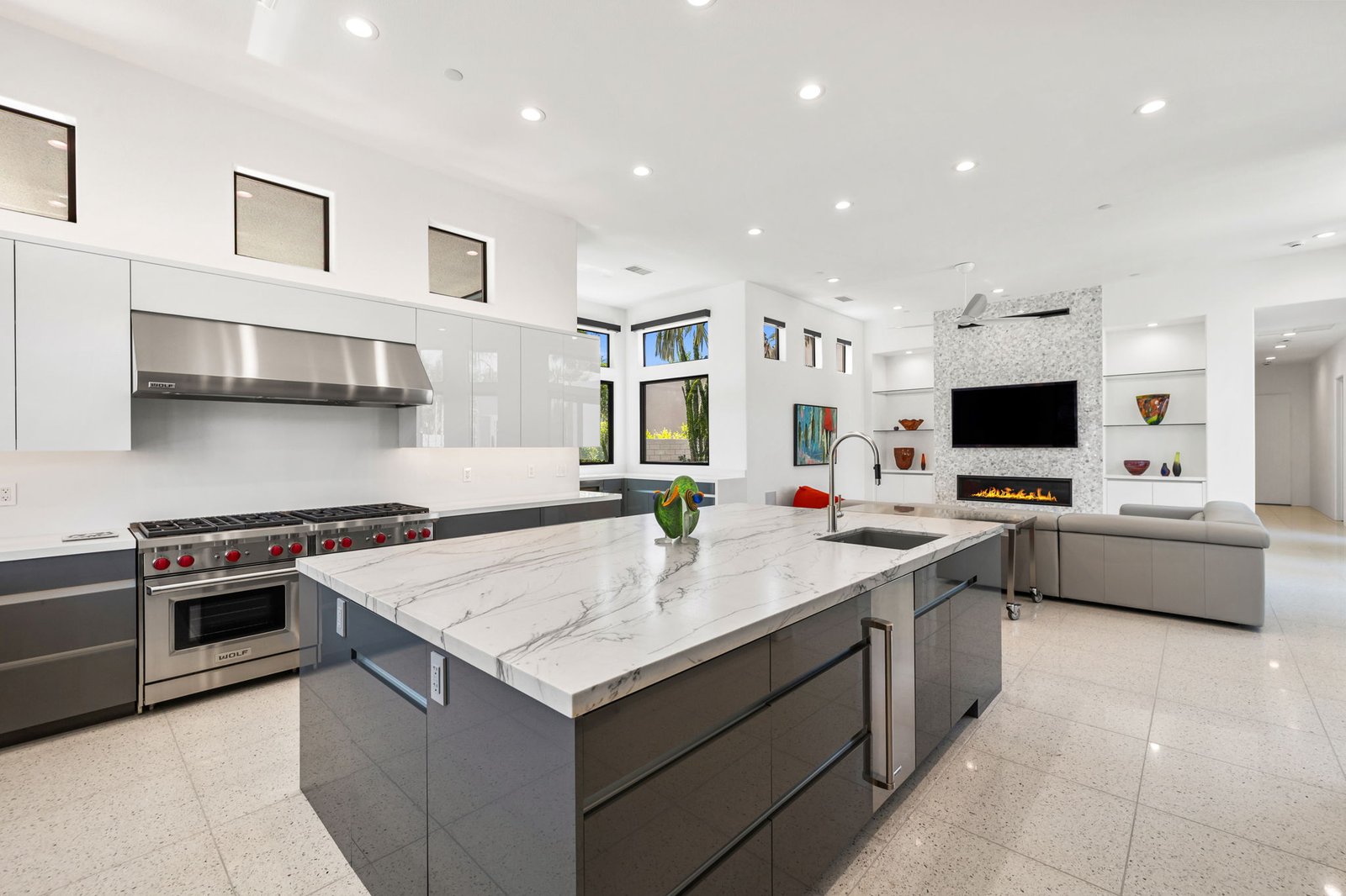 Complete kitchen and living room overview, Wolf range, fireplace wall, and island, Rancho Mirage