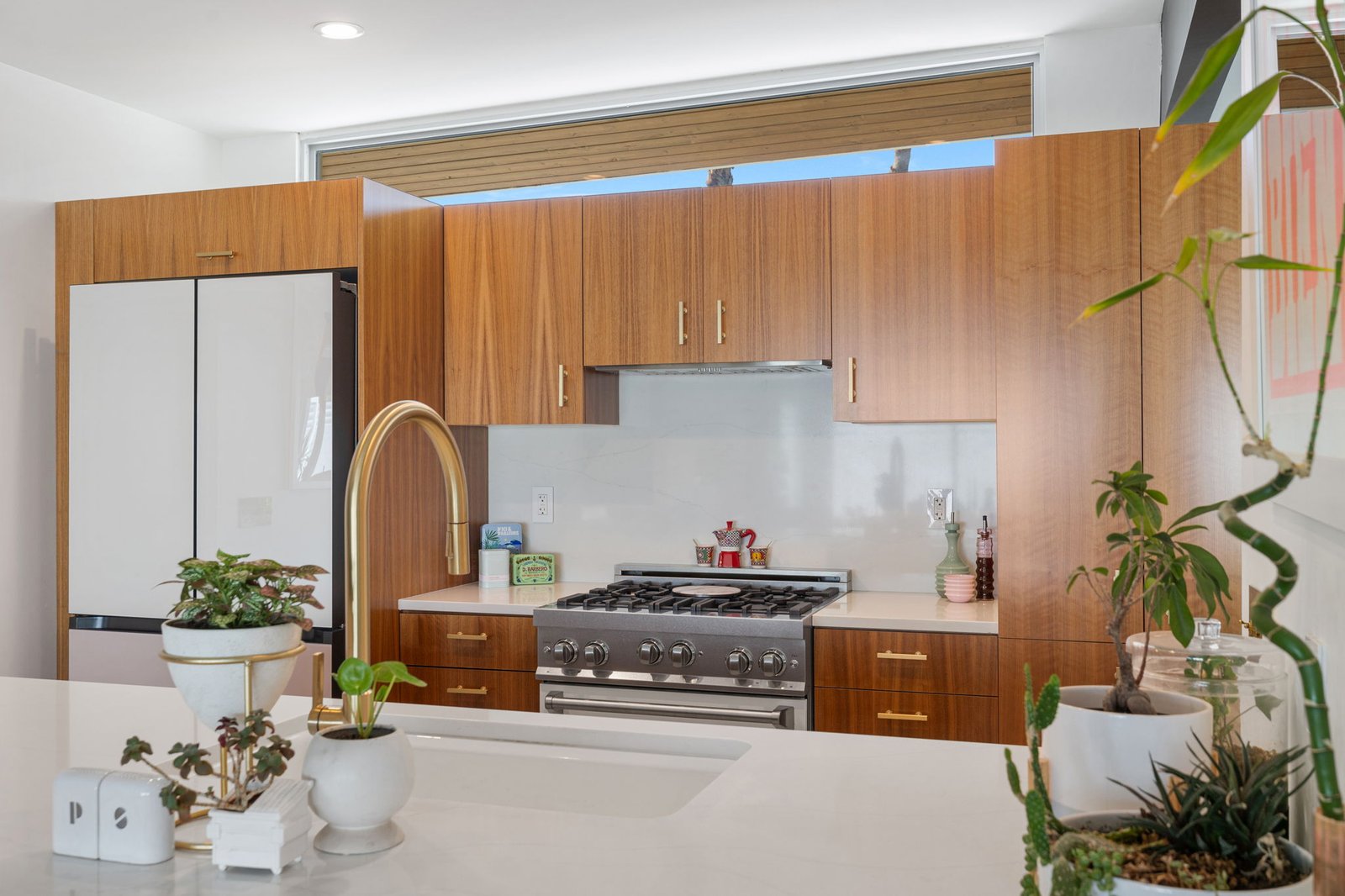 Bespoke fridge and ZLINE range both centered in walnut cook wall, Palm Springs kitchen